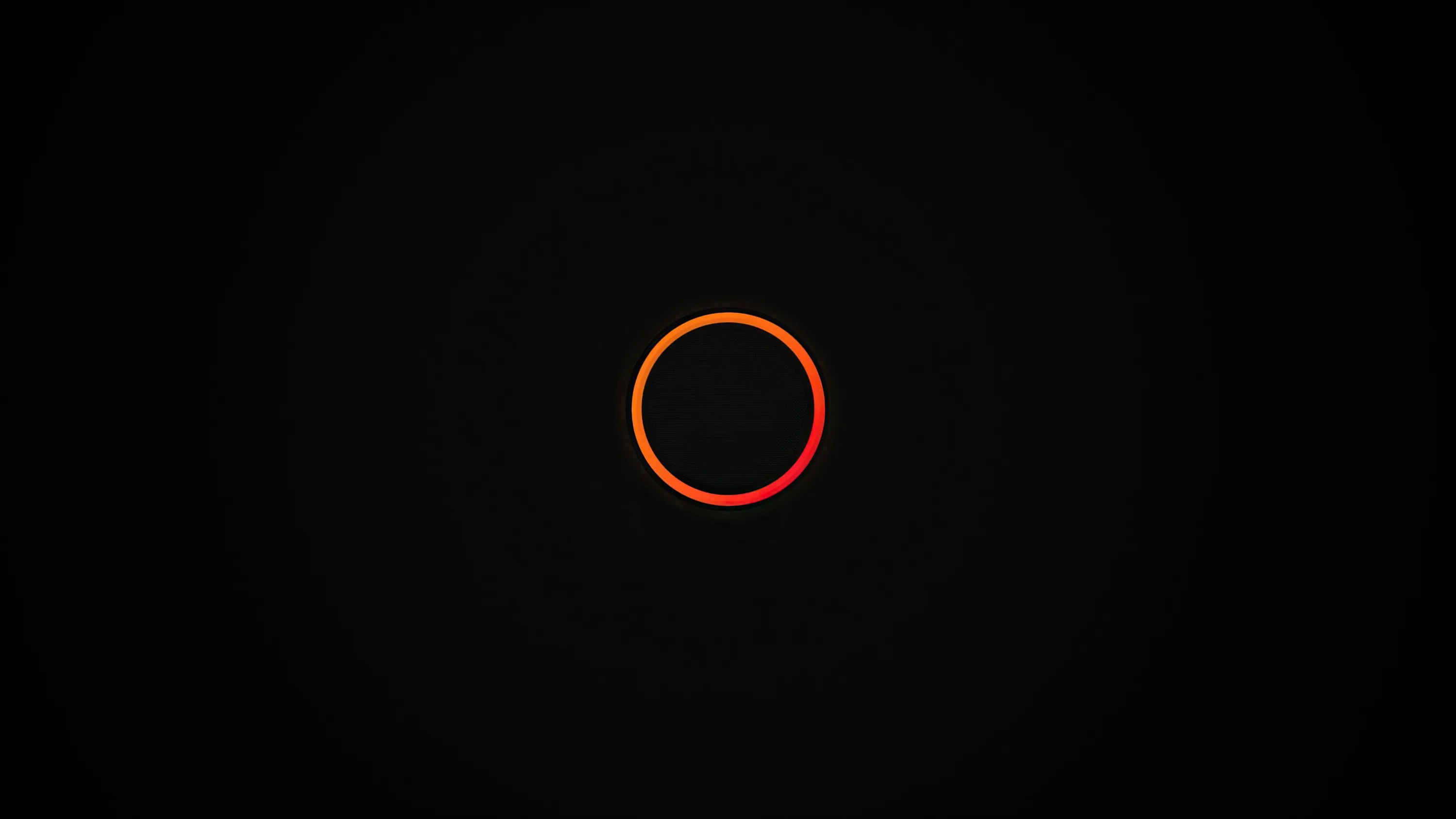 A single glowing ring sits slightly above centre on an empty black field, its light fading a few pixels out.