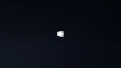 A small bright Windows logo floats just above centre in a deep navy-black space with a broad soft shadow filling the left side.