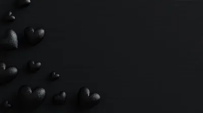 Textured black hearts gather along the left edge and lower corner, the right half left as one unbroken dark field for icons or text.