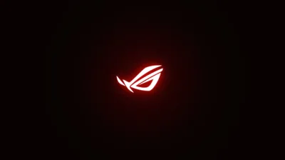 The ROG eye burns red at the middle of an otherwise empty black field, its glow bleeding out in a soft circular halo.