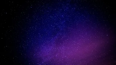 A dense starfield shifts from near-black blue into violet toward the lower right, with no foreground at all — clean enough to sit behind desktop icons.