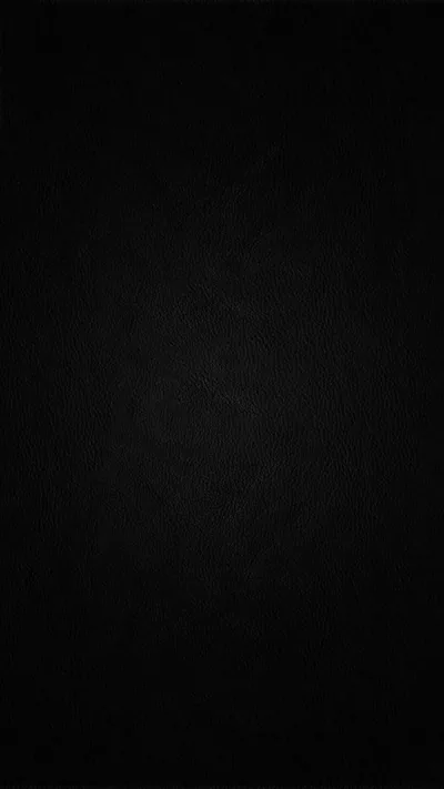 An almost solid black field with the faintest paper grain showing through, dark enough to switch off the pixels on an AMOLED screen.