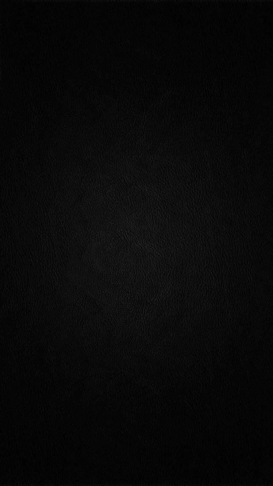 An almost solid black field with the faintest paper grain showing through, dark enough to switch off the pixels on an AMOLED screen.
