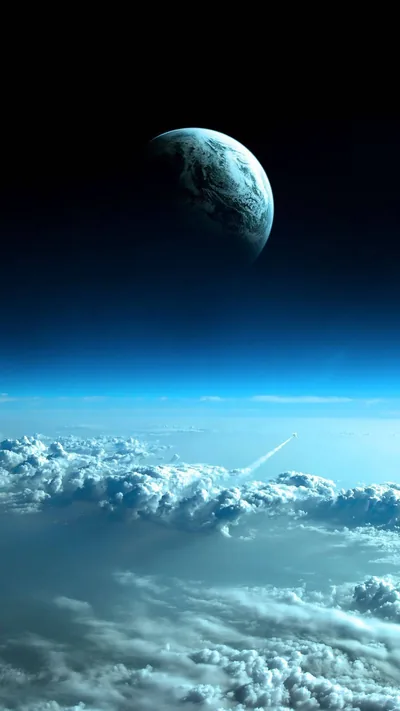 A cratered planet hangs low in a deep blue sky while thick cloud tops fill the bottom third, the upper edge fading almost to black.