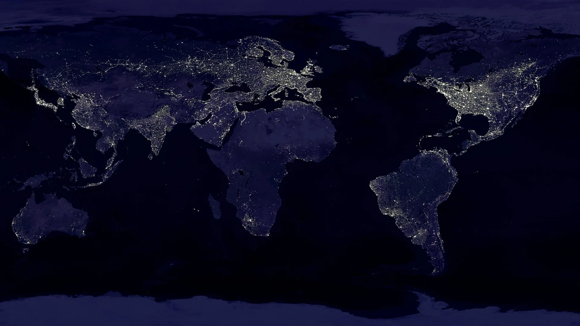 The whole flat map at night, continents traced only by their city lights — the US, Europe and Asia brightest — over oceans of near-black for OLED.