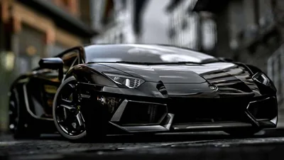 Low front shot of the Lamborghini between grey buildings, rain on the road ahead of it and the sharp creases of the bonnet picked out by weak daylight.