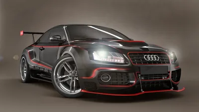 A widened Audi coupe on a plain grey studio backdrop, red pinstriping running the length of the body and a tall carbon wing sitting over the boot.