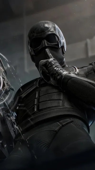 The masked figure crouches in matte black body armour with a blade drawn, goggles catching the only light in a grey concrete room.