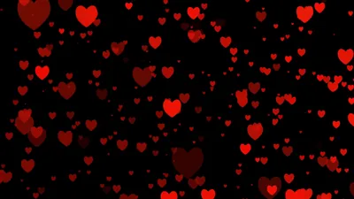 Dozens of red hearts float at different sizes and depths on solid black, the smaller ones dimmed almost to maroon.