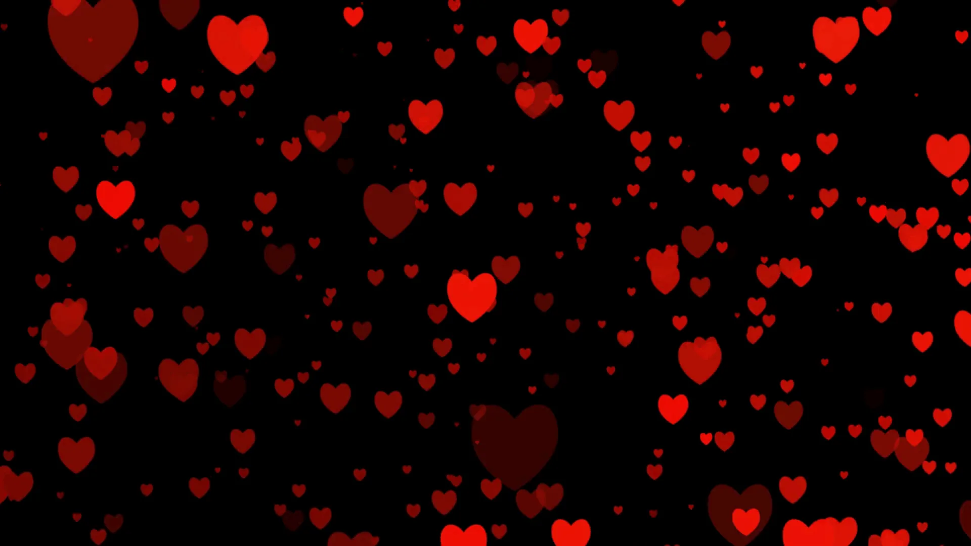 Dozens of red hearts float at different sizes and depths on solid black, the smaller ones dimmed almost to maroon.