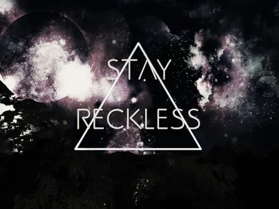 The words STAY RECKLESS sit inside a thin white triangle outline, laid over a washed purple galaxy with a dark planet at the left edge.