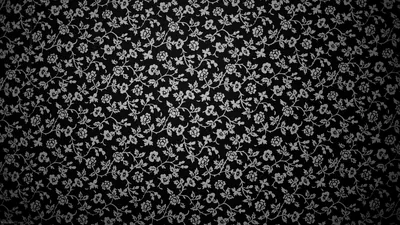 Hundreds of tiny five-petal blooms and stems crowd the frame in white, packed like an old cotton print with the corners dimmed by a soft vignette.