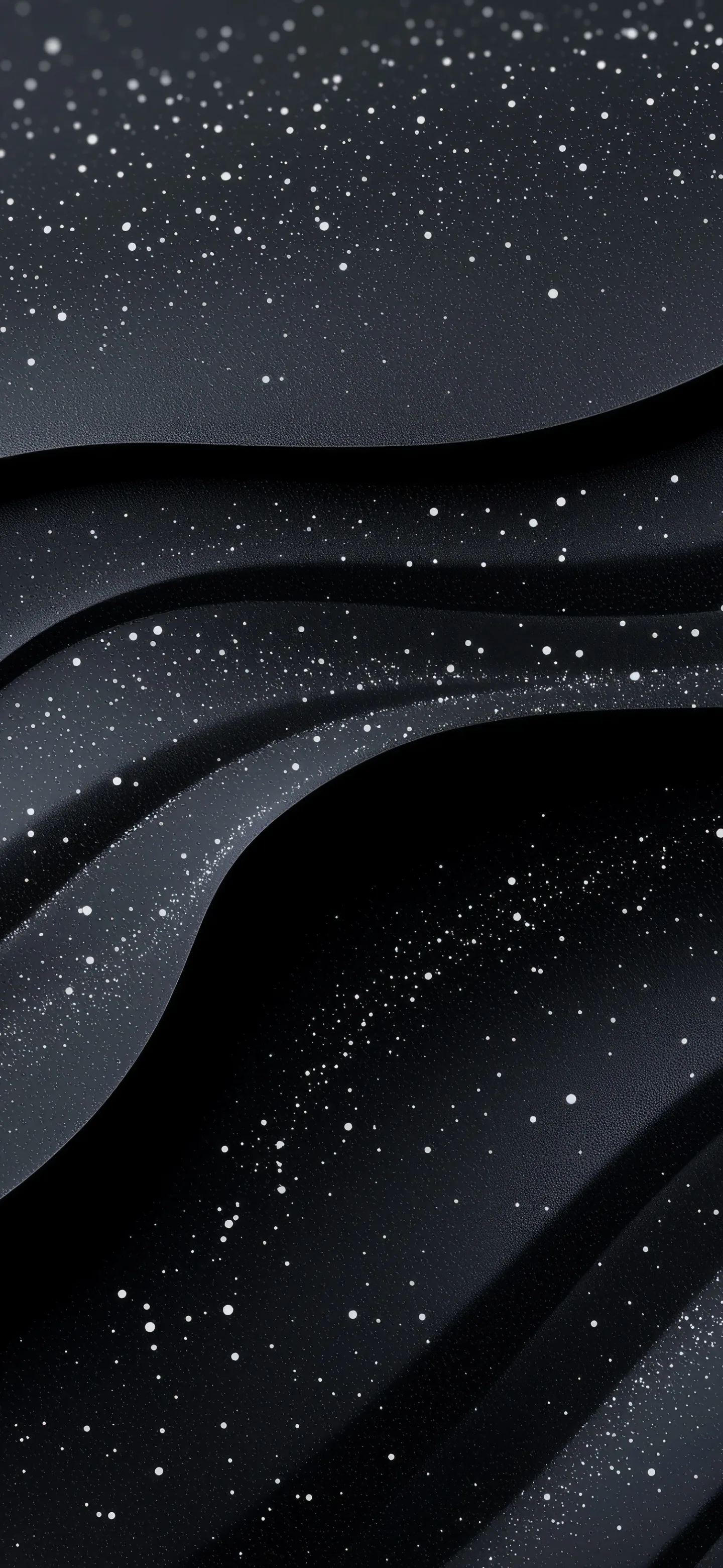Smooth charcoal ridges fold across a tall frame, scattered white specks drifting over them like fine sand.