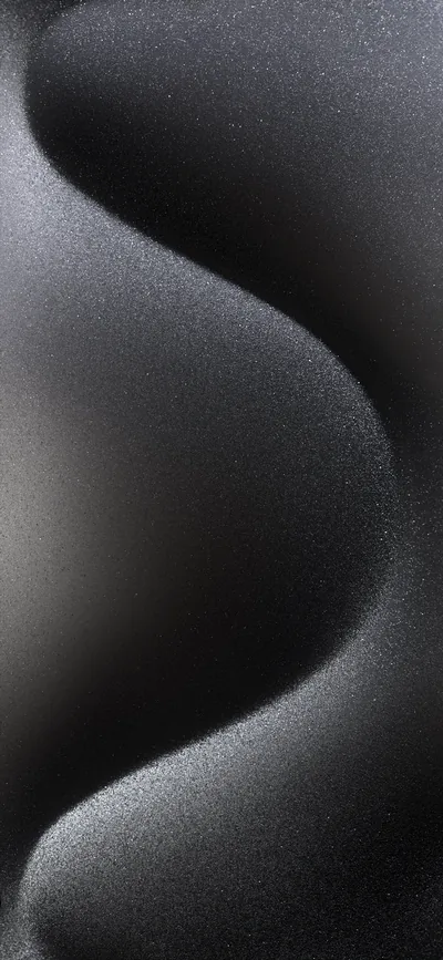 A single smooth curve of grey sweeps from top to bottom against black, its whole surface dusted with visible grain.