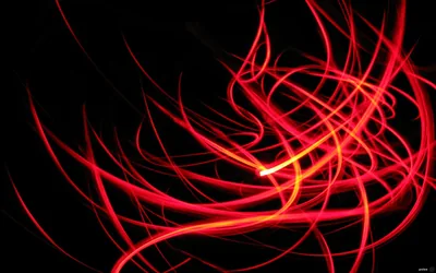 Long red trails curl and cross like ribbon caught in a slow shutter, brightest where they overlap just past the centre.