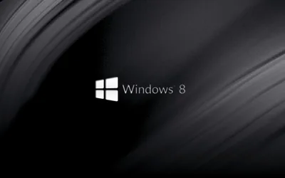 The white tilted mark and its name sit left of centre while broad grey curves sweep down the dark background behind them.