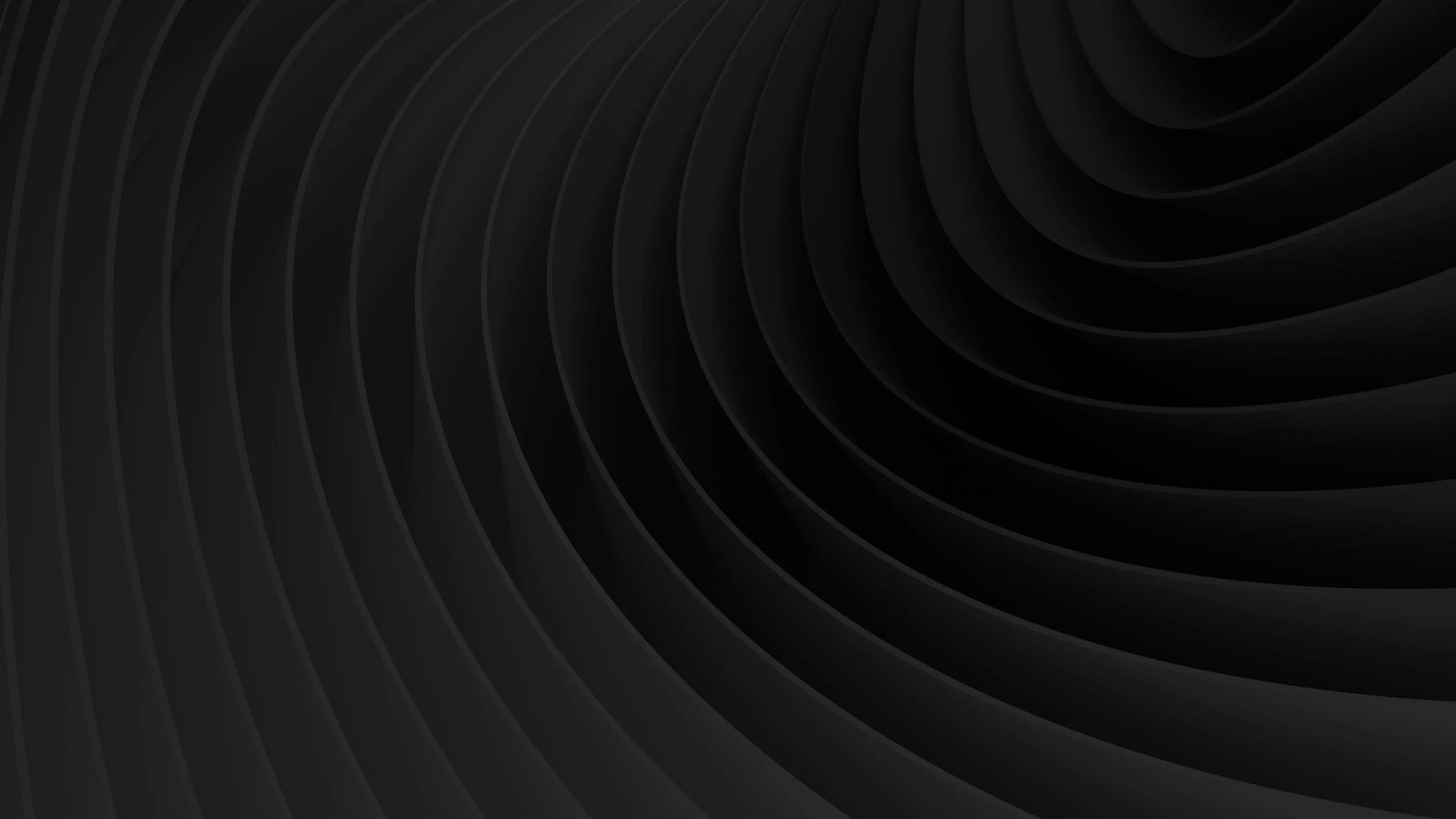 Concentric ridges sweep across the frame in a wide arc, each groove picked out by a narrow band of grey.