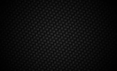 A tight carbon weave runs across the whole frame, the pattern only readable where light grazes the middle.