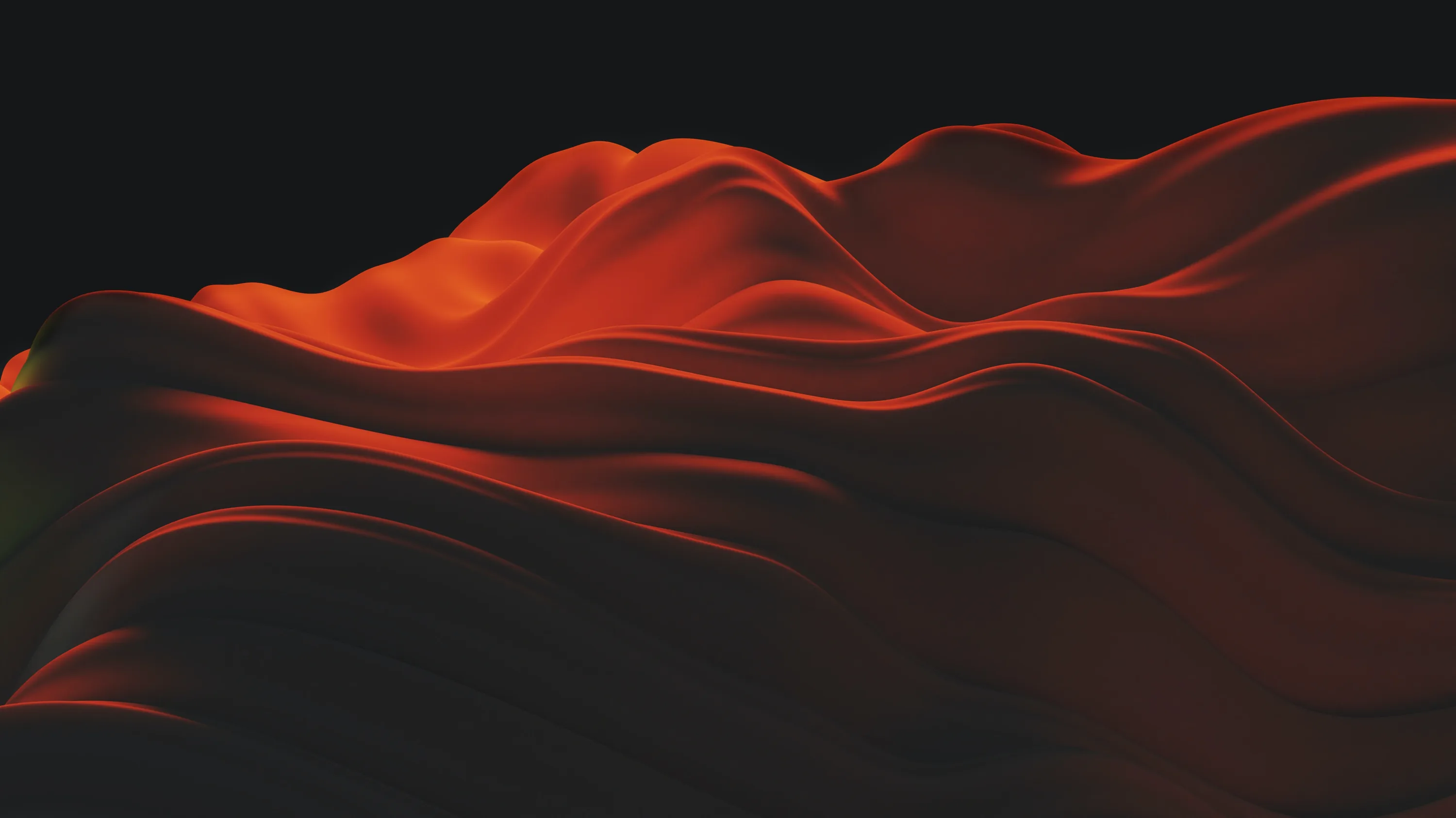 Folds of red satin roll like dunes across the lower half, the upper half held in complete black for a clean desktop workspace.