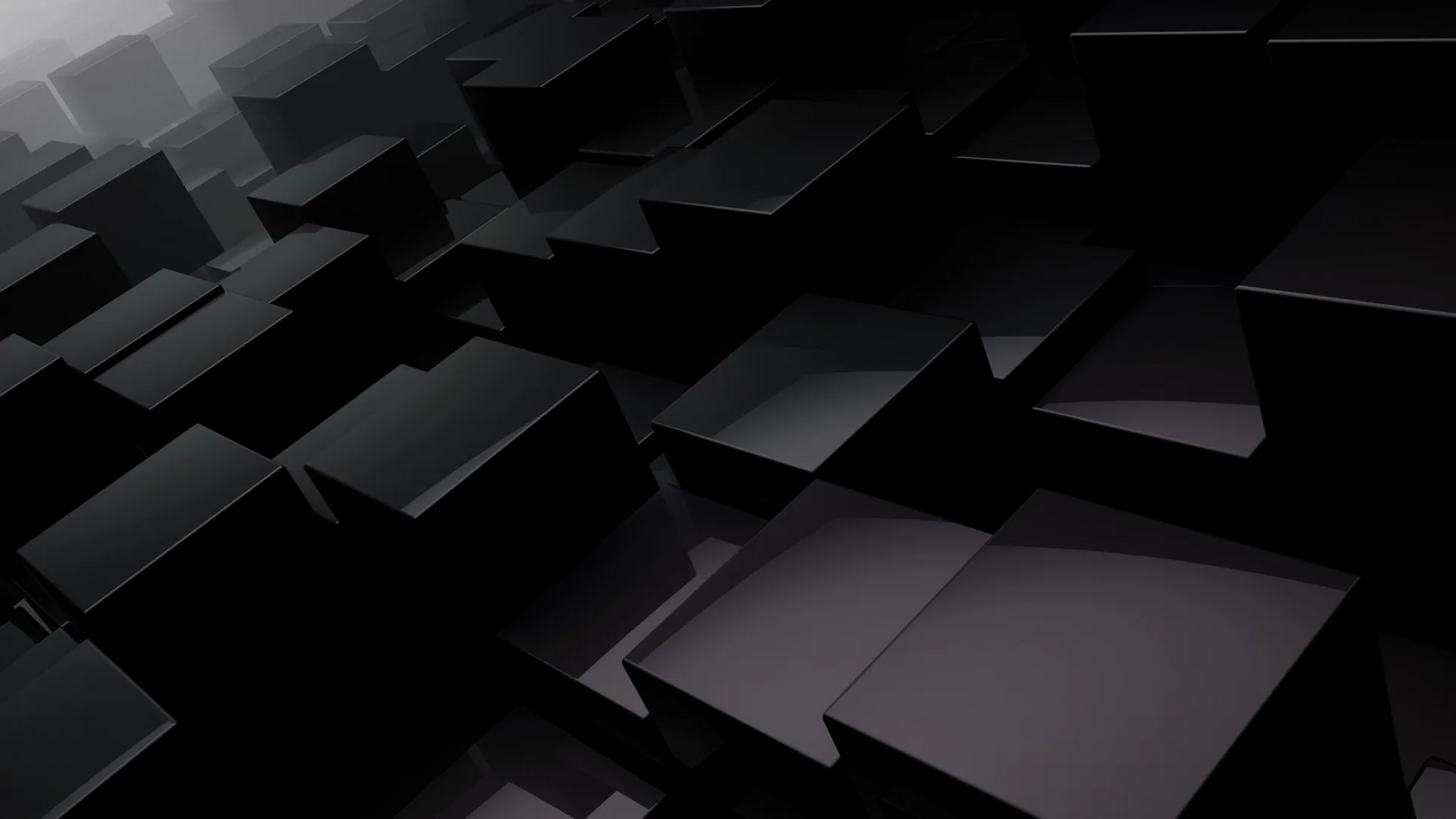 Dozens of matte black cubes pile up at odd angles, their top faces catching a weak overhead light.