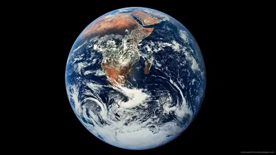 The famous full-disc view with Africa, Arabia and Antarctic cloud swirls, floating small on a wide black background that takes up most of the frame.