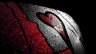 A heart is wiped clear through water beading on glass, deep red bleeding through the left side and the right fading into black.