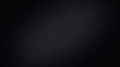 A wide soft light crosses a very dark navy field on the diagonal, leaving the corners in near-black.