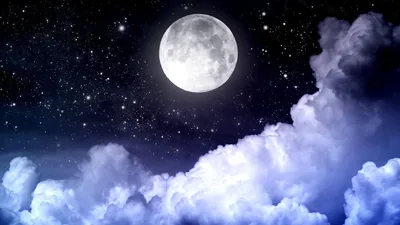 Night clouds pile up like snowdrifts beneath a bright full moon, stars dusting the black sky in the upper corners.