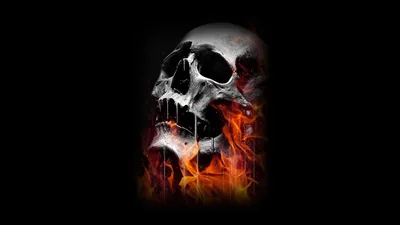 A cracked skull tilts back while fire climbs from below, warm orange and grey smoke against black on the right half of the frame.