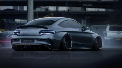 A rendered widebody coupe sits slammed over deep-dish wheels beneath a blurred city overpass, its blue-edged tail lights and quad exhausts reflected faintly in the wet ground.