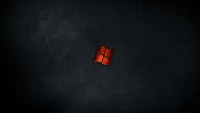 A red four-pane mark sits small at the centre of a mottled dark grey wall with a faint glow around it.
