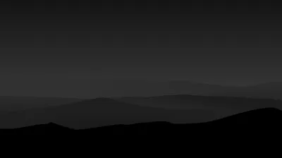 Overlapping ridgelines fade from black in the foreground to faint grey haze at the skyline, the upper half left almost empty.