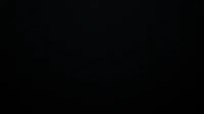 Something faintly angular sits at the centre of an otherwise unlit frame, visible only as a shift in tone rather than an outline.