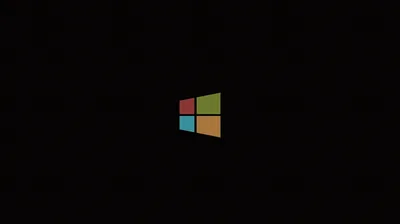 The four-pane Windows flag in red, green, blue and yellow floats mid-frame on true black — good contrast for OLED screens.