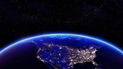 City lights map out the United States and Mexico under a deep blue glow, the atmosphere rim arcing against black space in the upper half.
