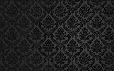 A damask repeat sits raised on charcoal, lit brightest through a horizontal band across the middle and sinking to black at the corners.