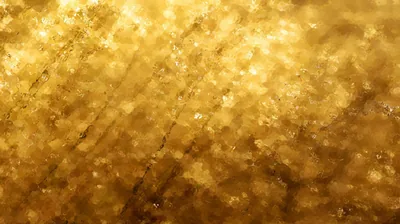 Out-of-focus glitter melts into a molten blur, faint vertical streaks running down the frame like dripping metal.