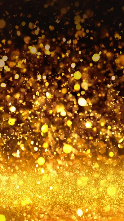 Fine gold particles drift up from a bright glowing base into darkness, so the top of the phone screen stays dim enough for the clock.