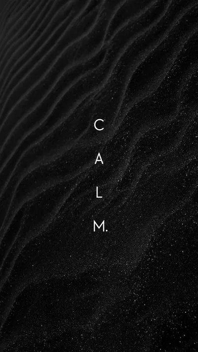 The word CALM set in thin white letters down the centre of a rippled black dune, sand grains glittering across the lower half.