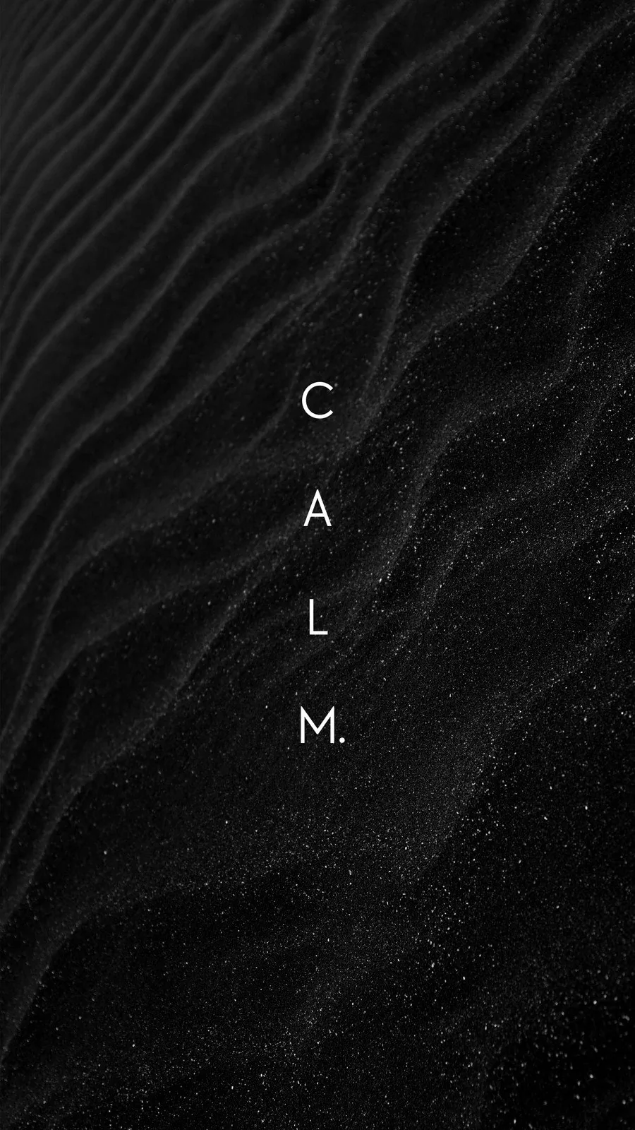 The word CALM set in thin white letters down the centre of a rippled black dune, sand grains glittering across the lower half.
