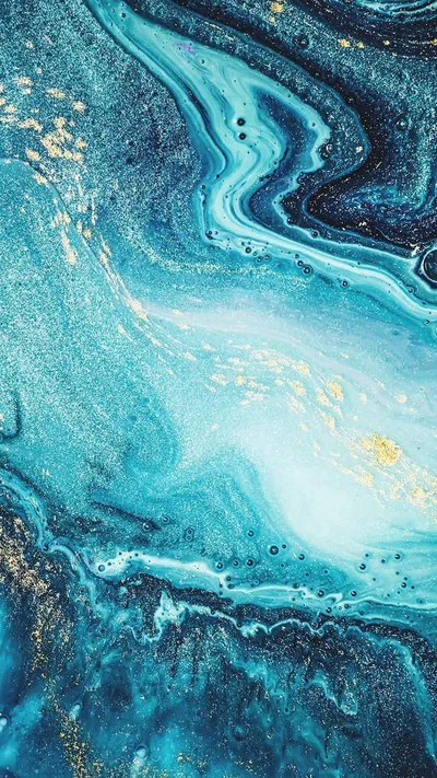 Aqua and teal ink swirl around a milky centre dusted with gold glitter, the darkest navy band holding the upper right corner of the frame.