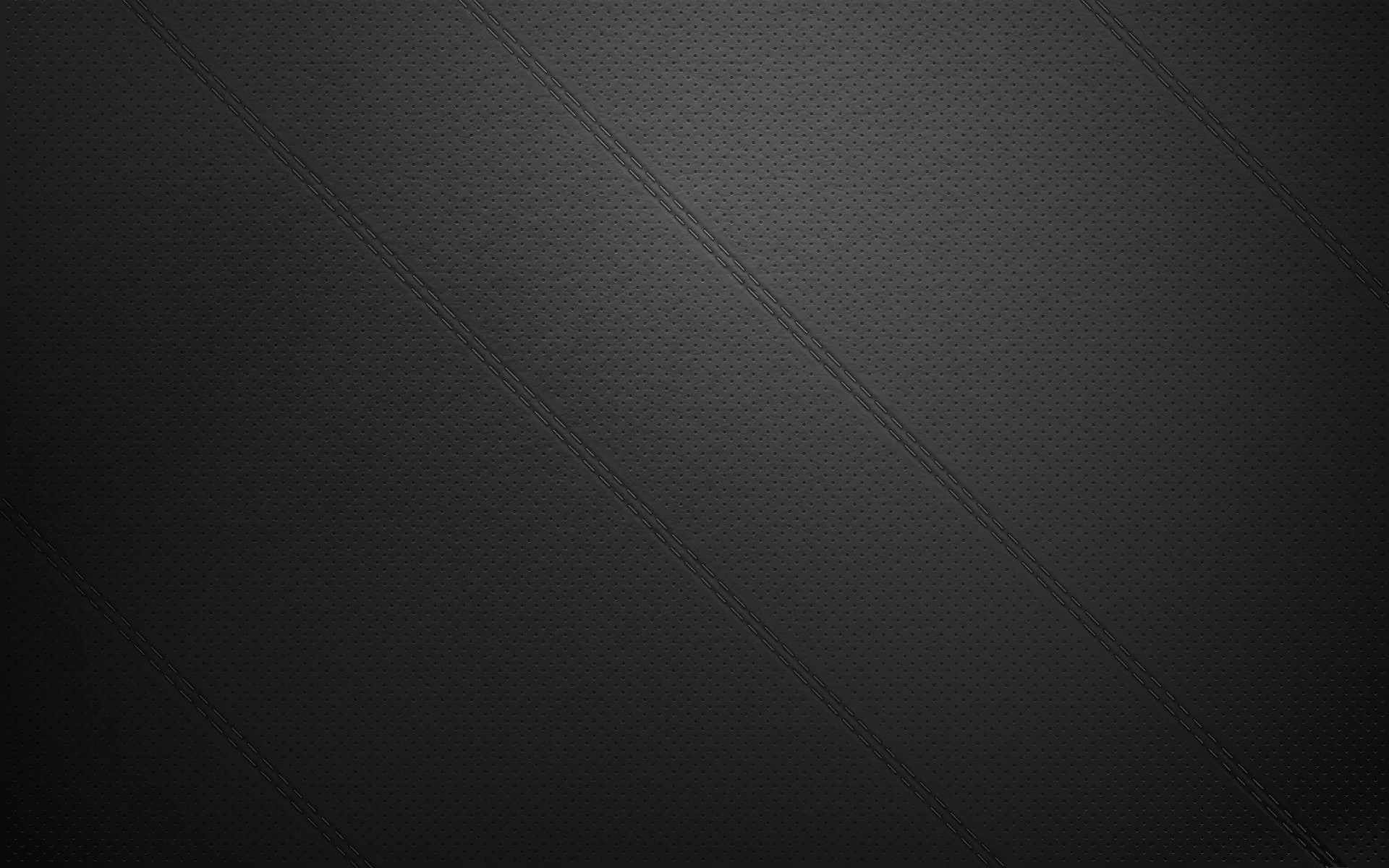 A finely pebbled grey surface lifts slightly toward the centre, crossed by two faint diagonal seams that run from the top edge down past the middle.