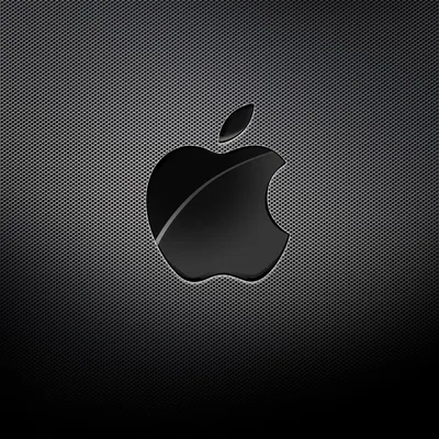 A glossy black Apple logo with one sweeping highlight sits centred on a fine carbon fibre grid that lightens toward the middle.