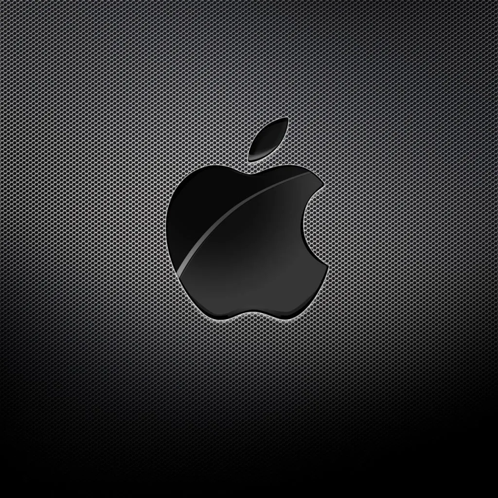 A glossy black Apple logo with one sweeping highlight sits centred on a fine carbon fibre grid that lightens toward the middle.