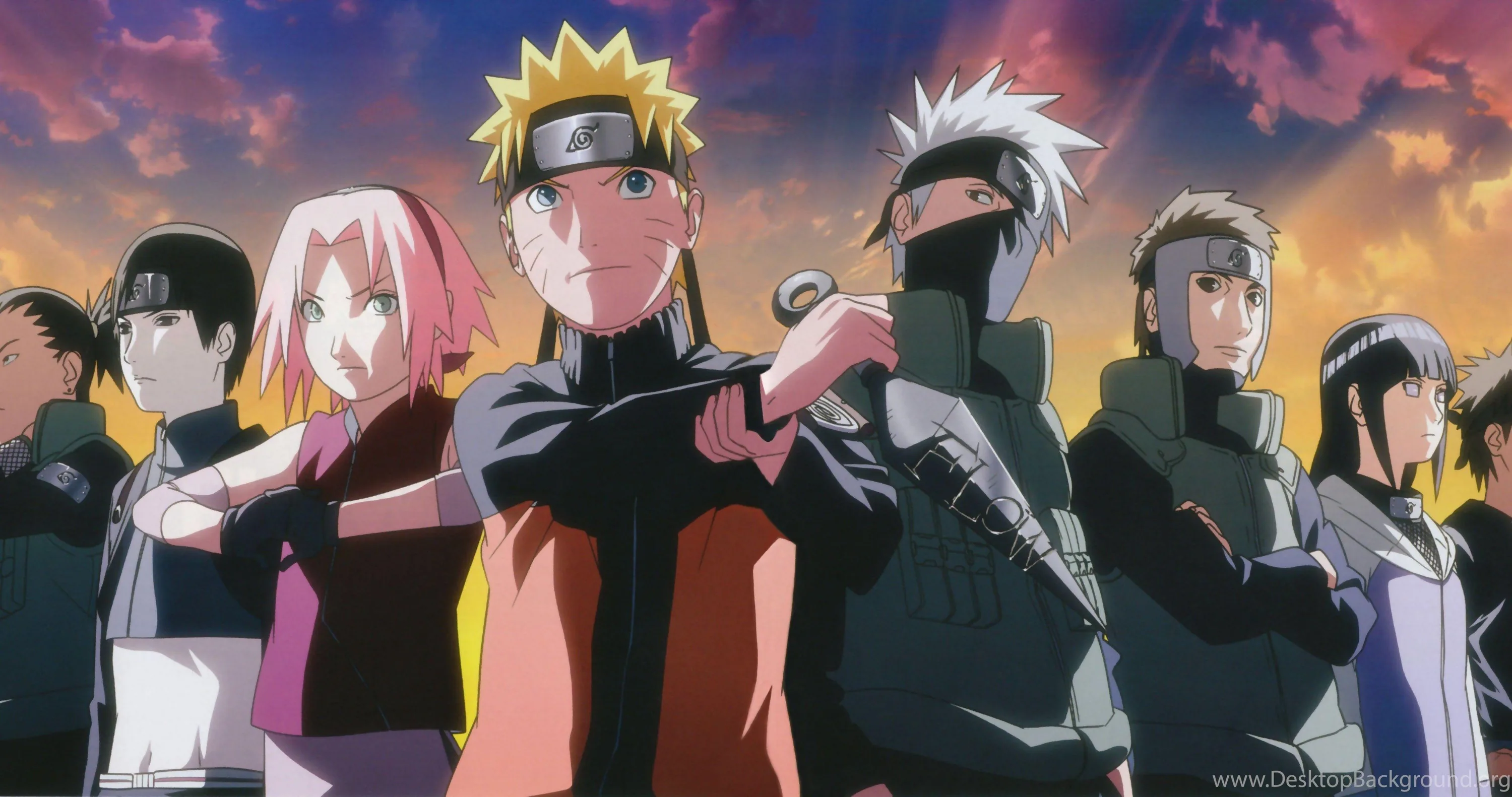 Naruto leads a shoulder-to-shoulder row of leaf ninja — Sakura, Kakashi, Hinata and more — under streaked sunset clouds in an extra-wide frame.