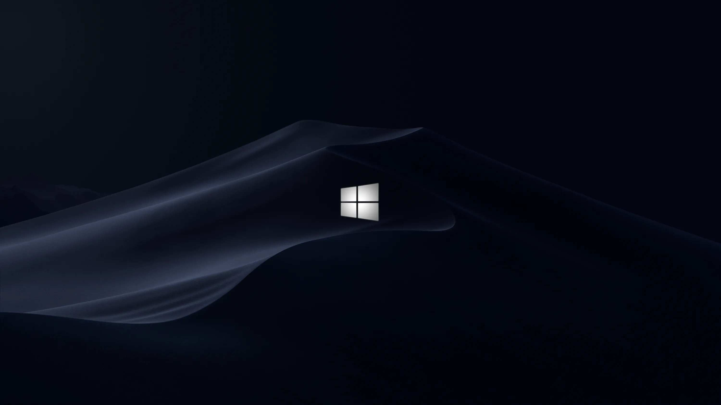 Dark blue dunes of silk sweep across the lower half, a small white Windows flag glowing where two ridges meet.
