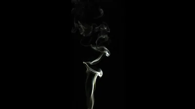 One thin ribbon of white smoke rises up the middle of the frame, curling apart near the top.