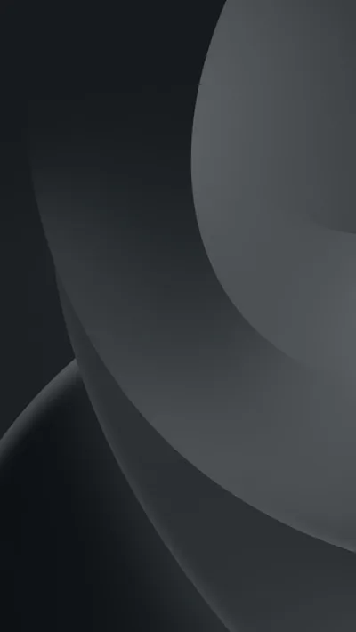 Two broad circular edges sweep through the frame in slightly different greys, the top left corner left dark and uncluttered.