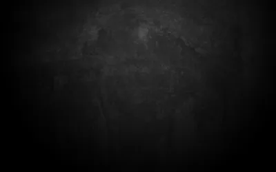 A charcoal concrete surface scuffed and blotched across the upper half, the edges pulled down into a heavy vignette.