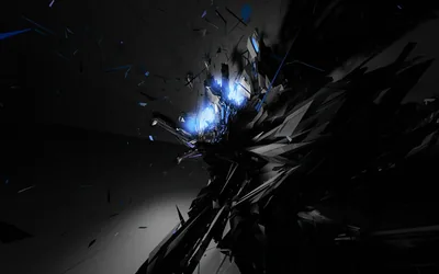 Jagged black fragments blow apart across the right of a plain grey studio wall, blue-white light flaring from the point they came from.